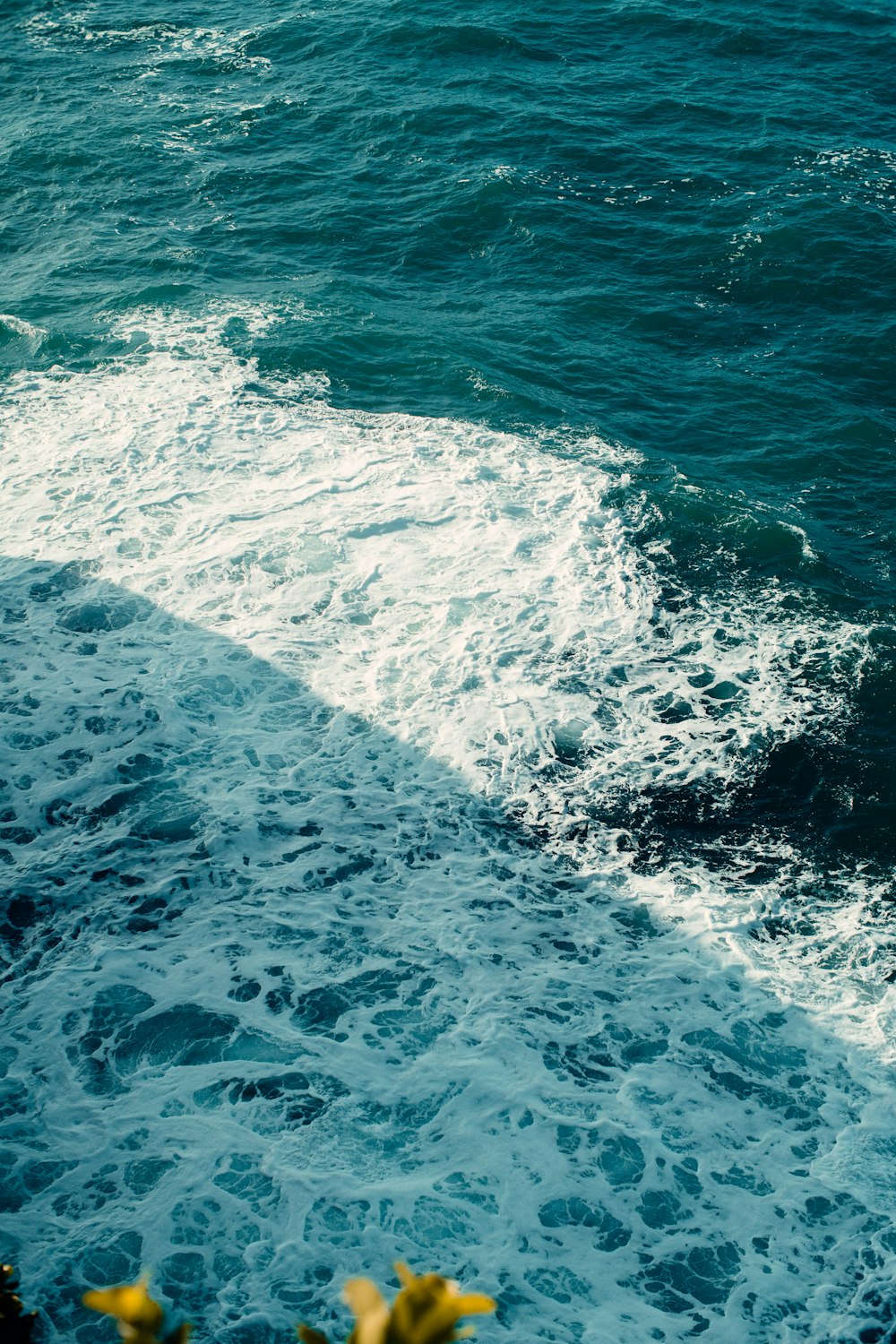 a man riding a surfboard on top of a wave in the ocean