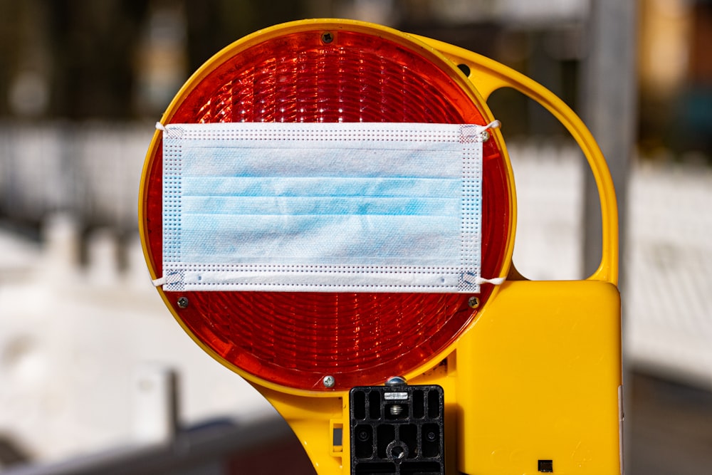 a traffic light with a face mask on it