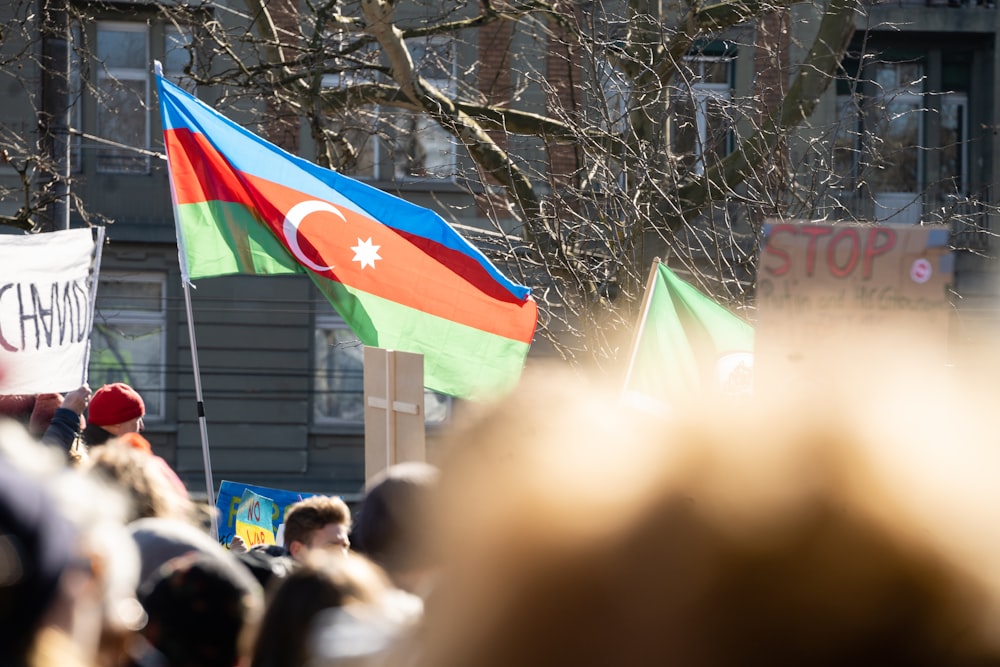 a group of people holding flags and signs