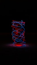 Glowing neon coin spinning against a dark futuristic background.