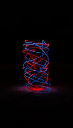 Glowing 3D zodiac wheel spinning against a dark cosmic background with neon purple and blue highlights.