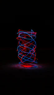 Glowing 3D zodiac wheel spinning against a dark cosmic background with neon purple and blue highlights.