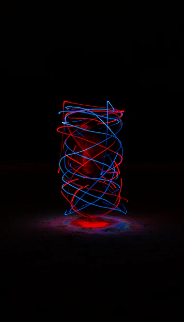 A high-resolution cinematic background showing glowing mitochondrial networks and DNA helix structures in vibrant orange and neon green against a dark charcoal gradient.