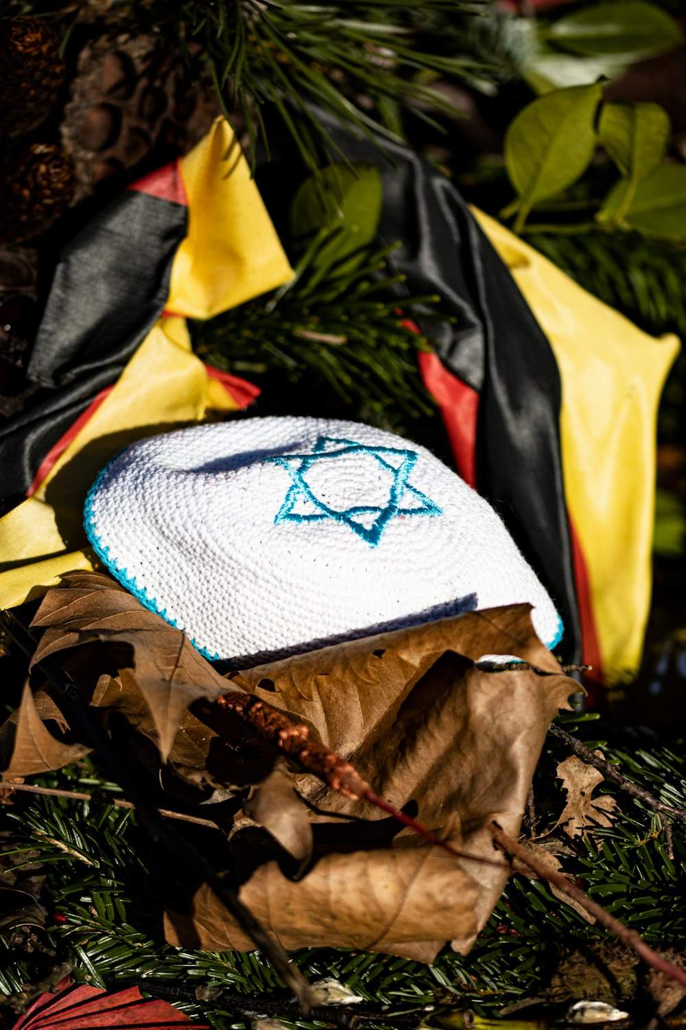 a white and blue object sitting on top of a pile of leaves