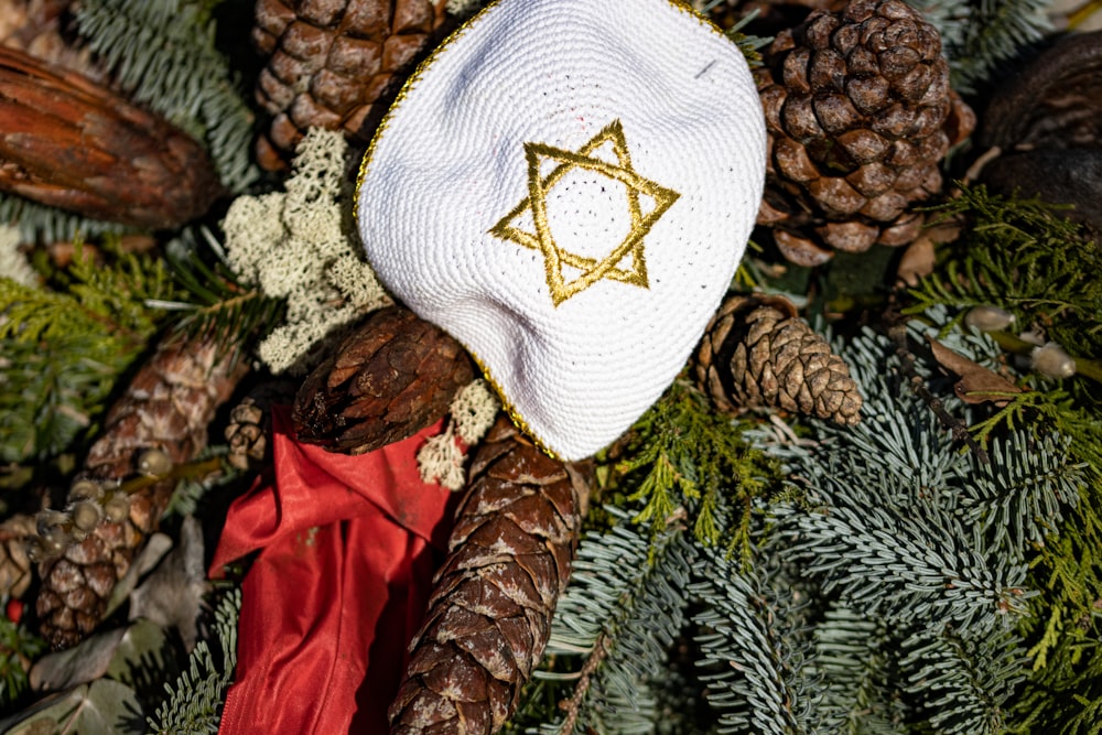 a white hat with a star of david on it
