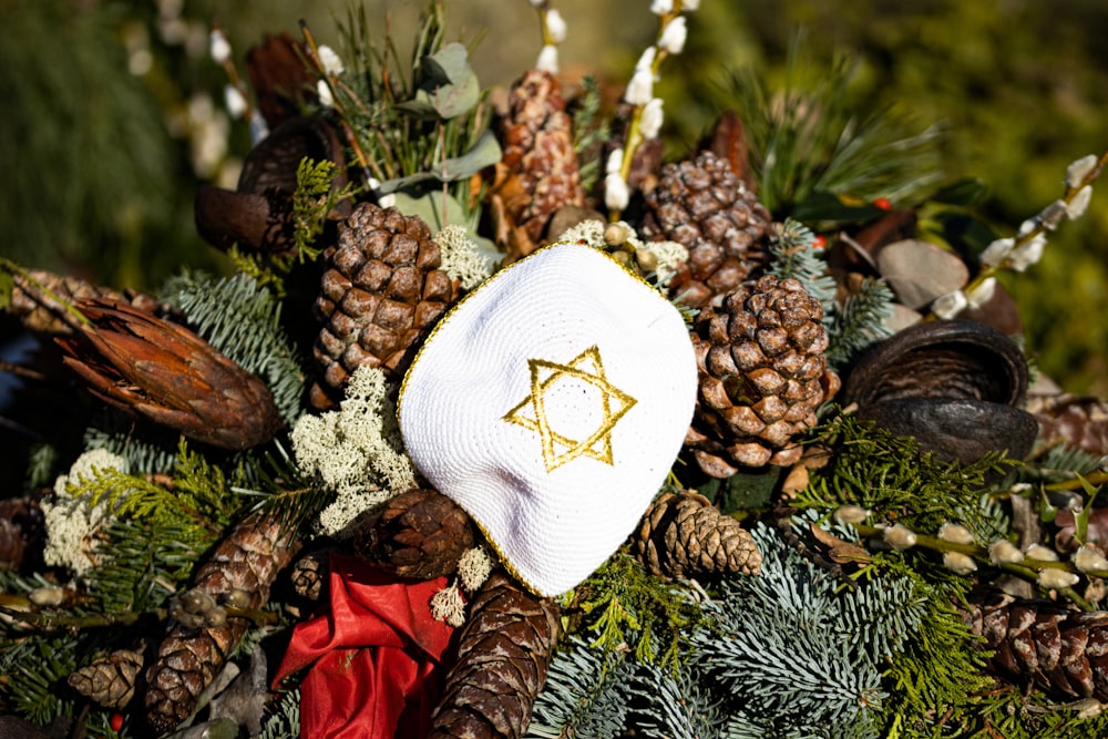a wreath with pine cones and a star of david on it