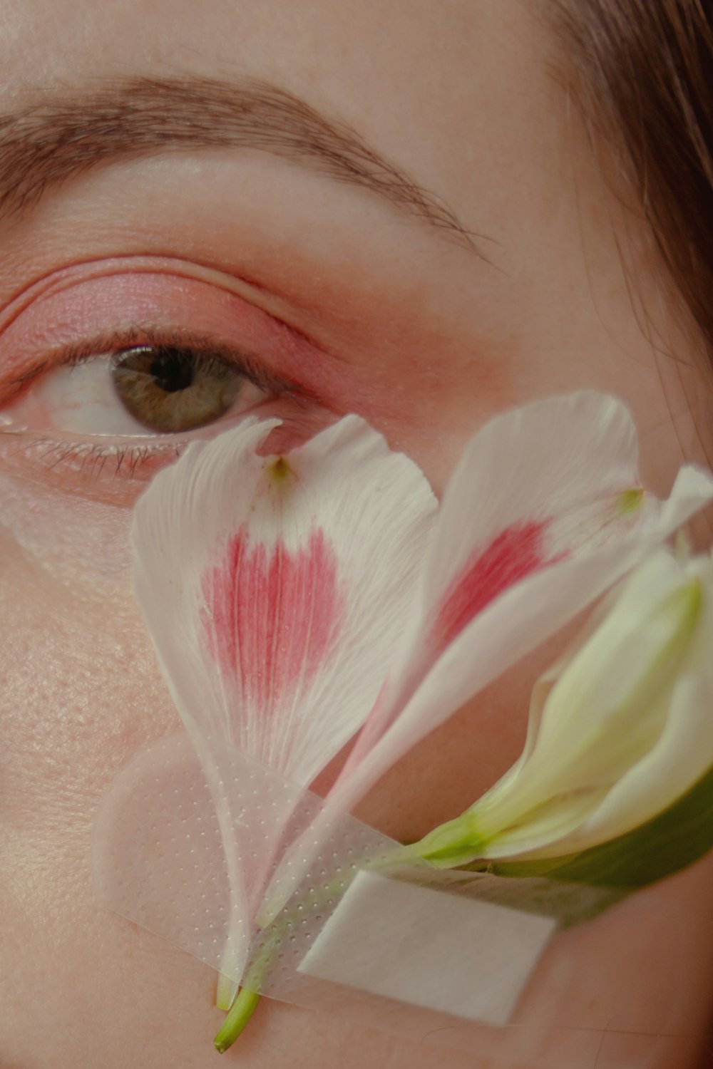 a close up of a person with a flower in their eye