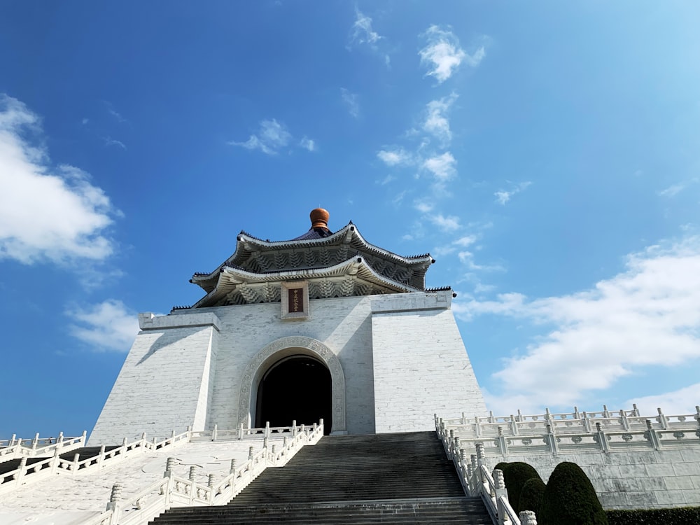 a large white building with stairs leading up to it