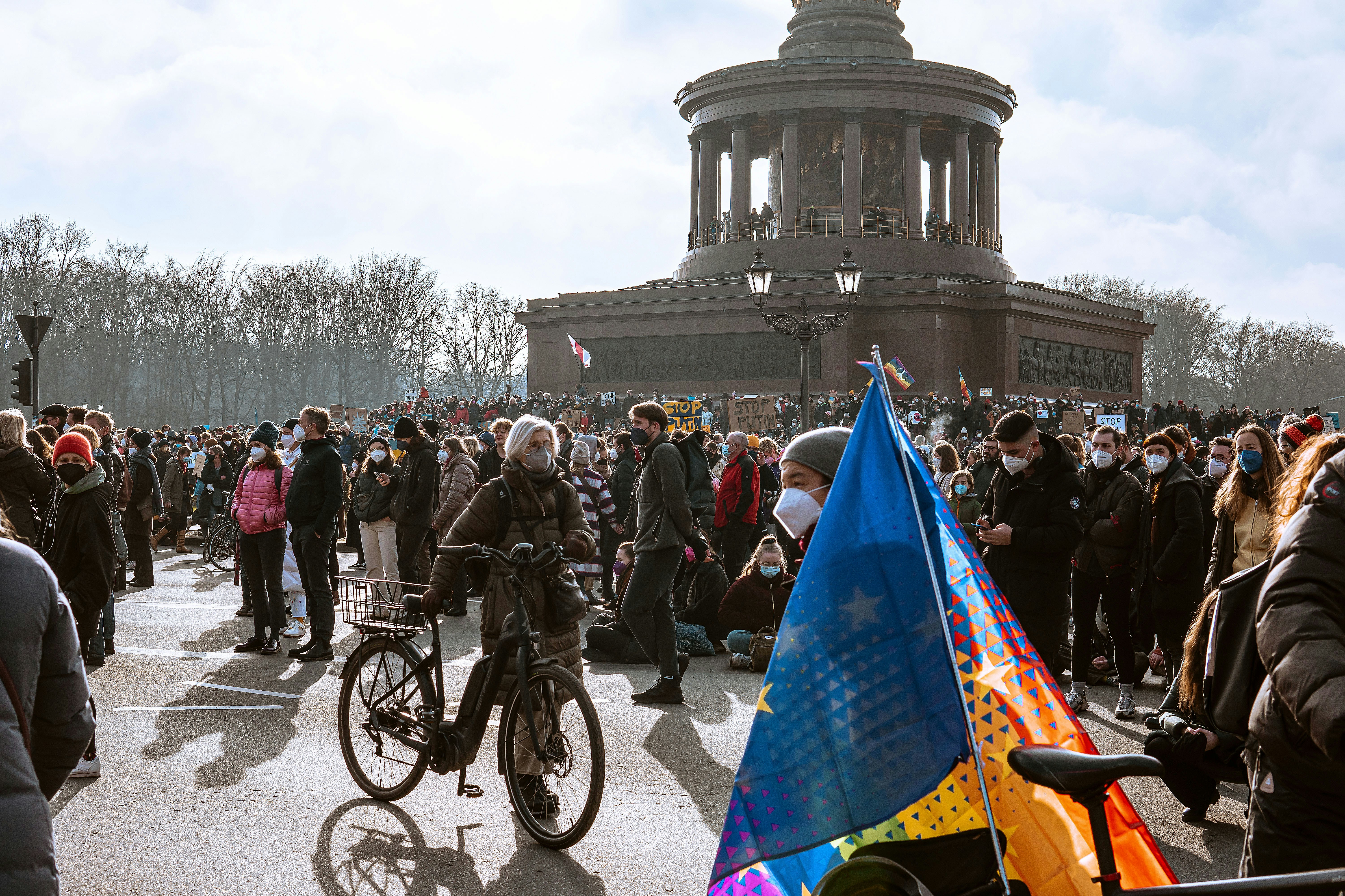 a large group of people standing around a building