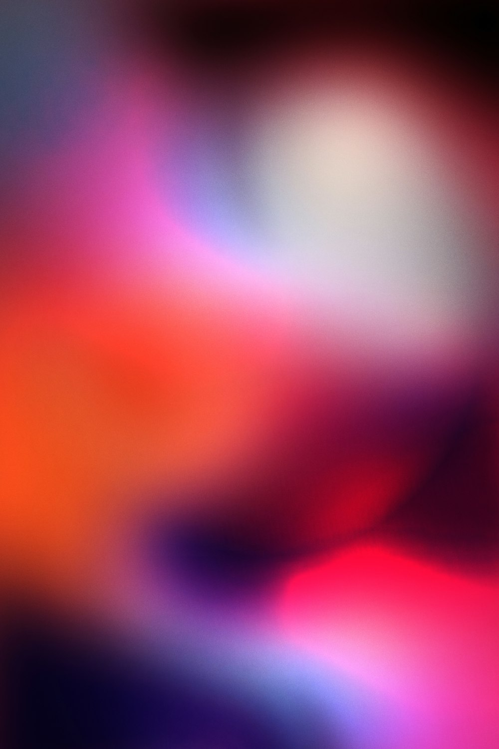 a blurry image of an orange and pink background