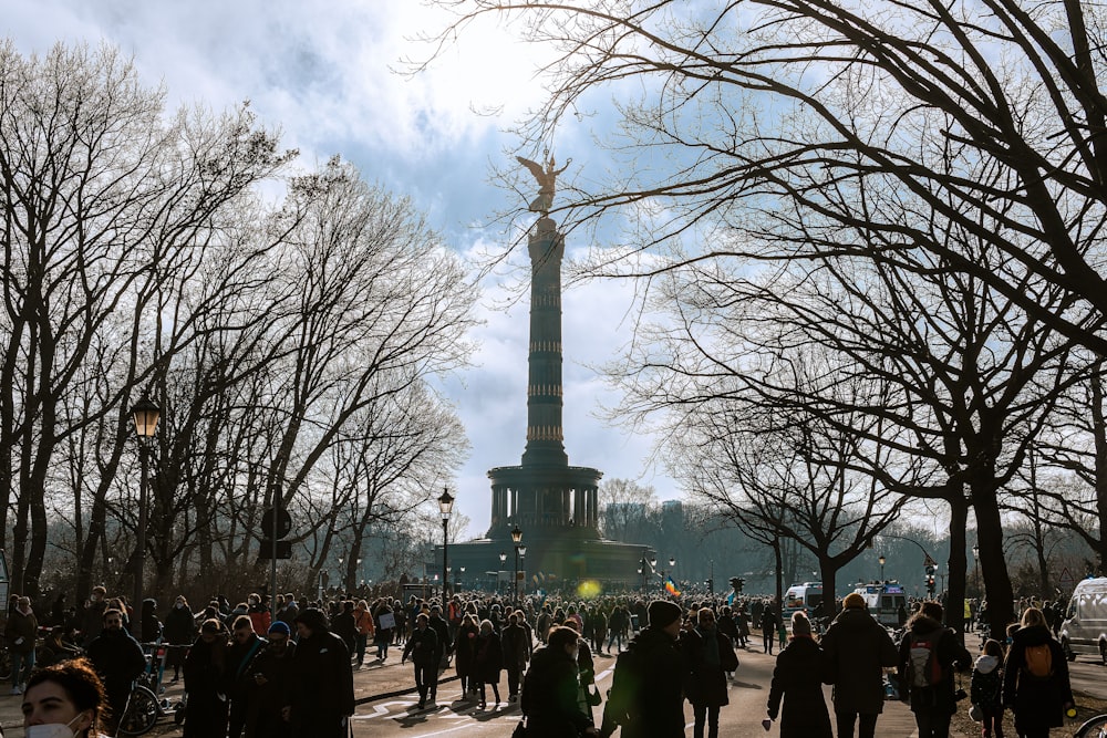 a crowd of people walking around a park