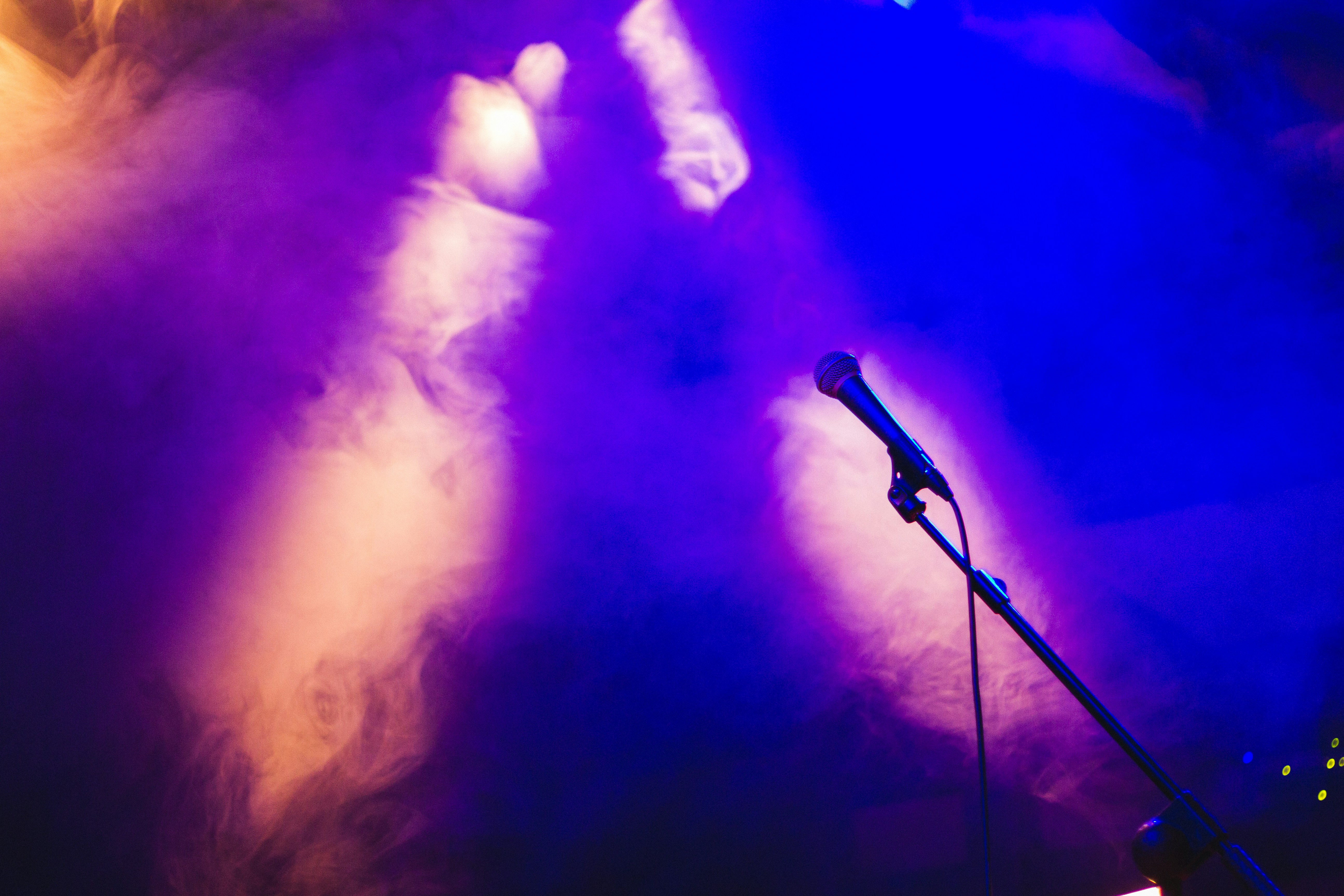 a microphone on a stage with purple lighting