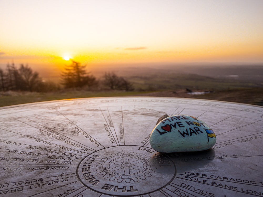 a stone sitting on top of a table covered in writing