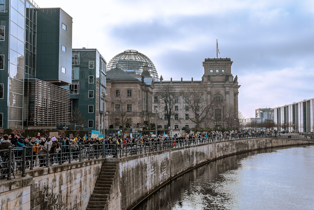 a group of people standing on a bridge over a river