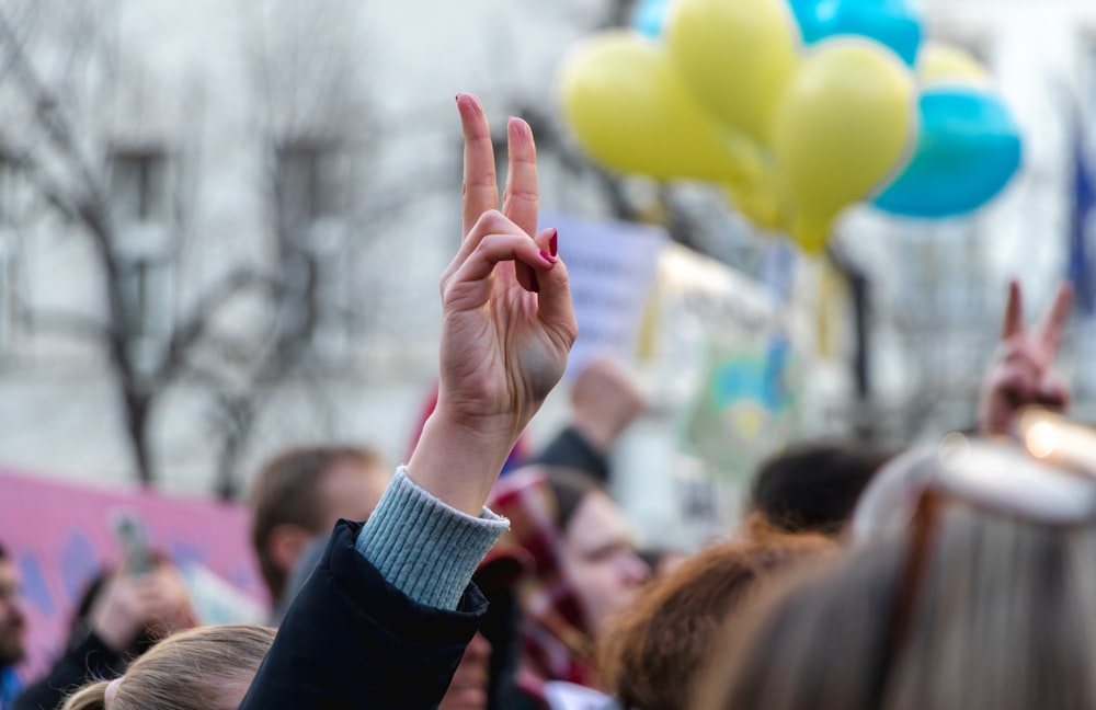 a group of people holding up their hands in the air