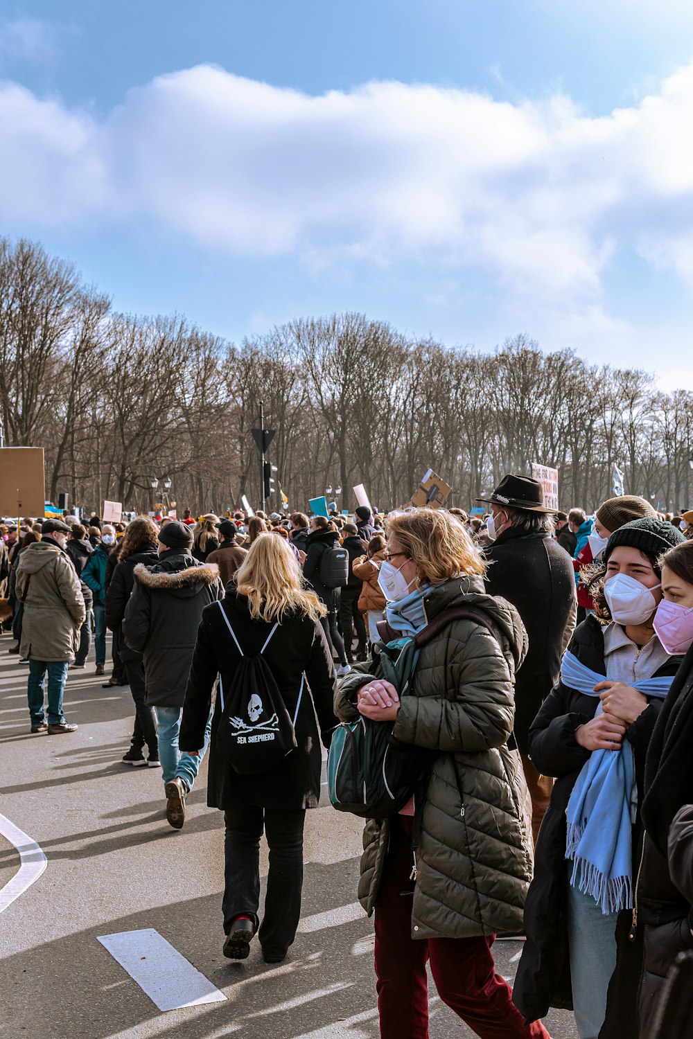 a large group of people walking down a street