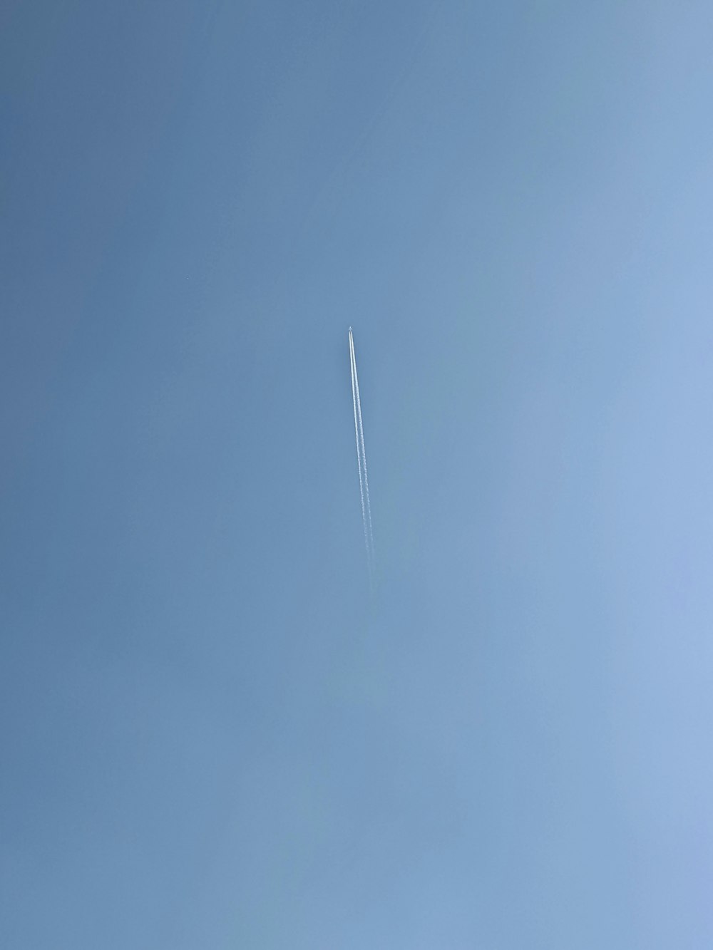 an airplane is flying high in the sky