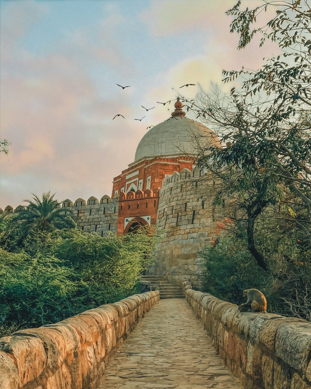 a painting of a stone bridge with a building in the background