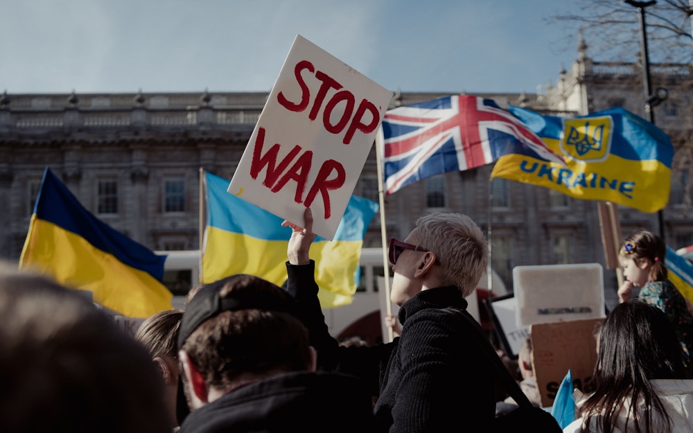 a group of people holding up signs and flags