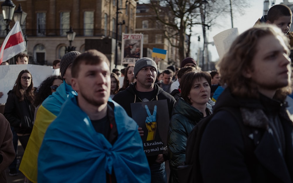 a large group of people walking down a street