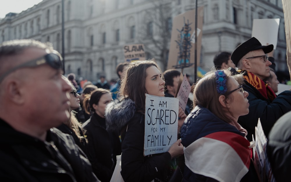 a group of people holding signs in front of a building