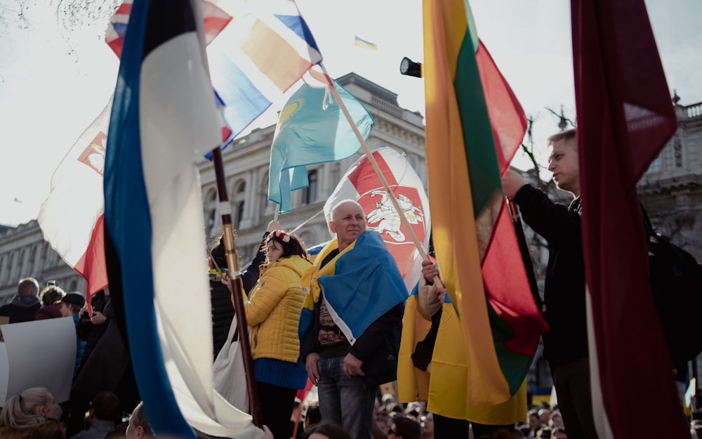 a group of people holding flags in a crowd