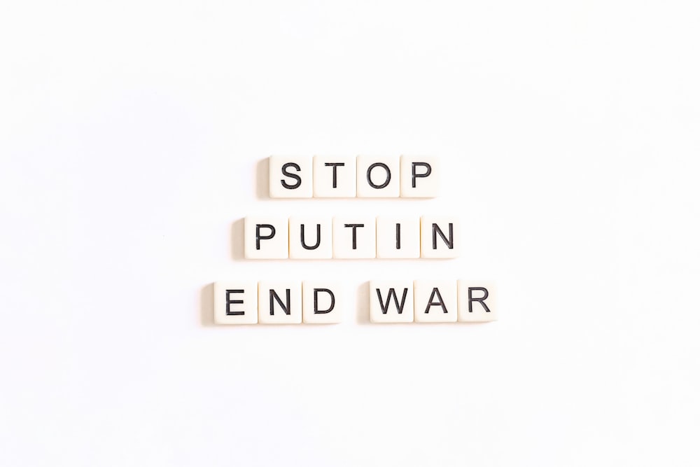 scrabble letters spelling the word stop, put in end war