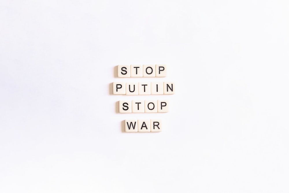 scrabble tiles spelling stop, puttin, stop, war