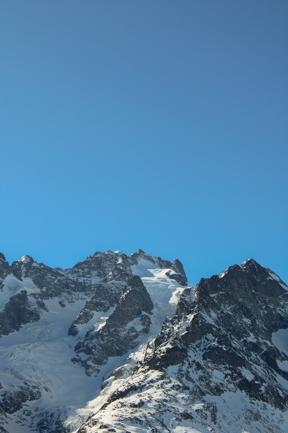 a snow covered mountain with a clear blue sky