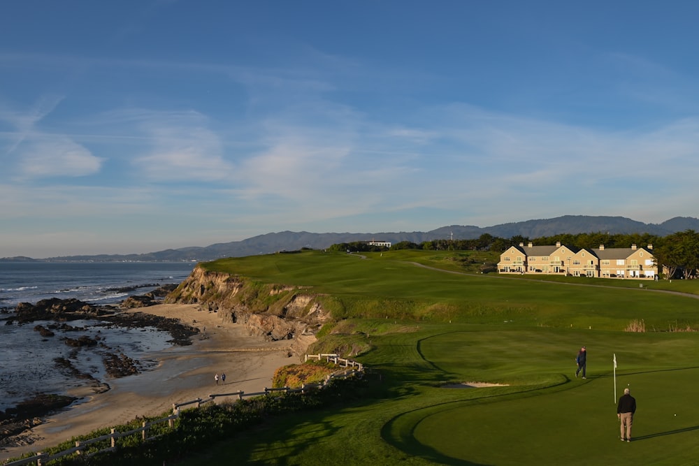 a person on a golf course near a body of water