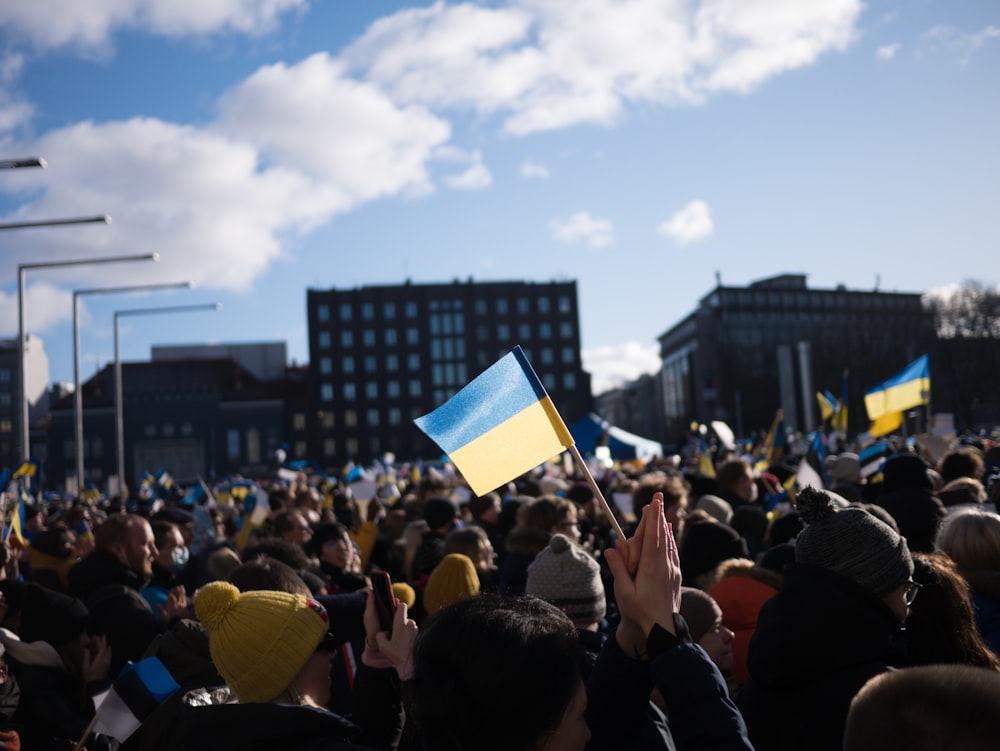 a large crowd of people holding up flags