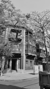 A black-and-white photograph of a quiet, abandoned corner in Brest with soft shadows revealing forgotten details.