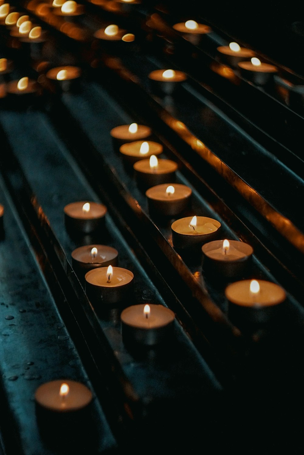 a bunch of lit candles sitting on top of a table