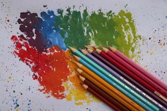 a group of colored pencils sitting next to each other
