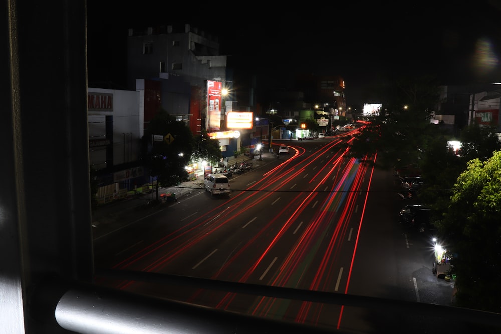 a view of a city street at night from a bus window