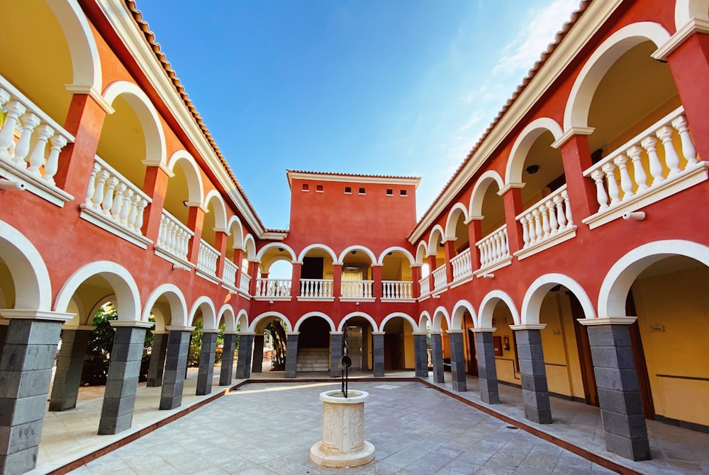 a courtyard of a building with arches and pillars