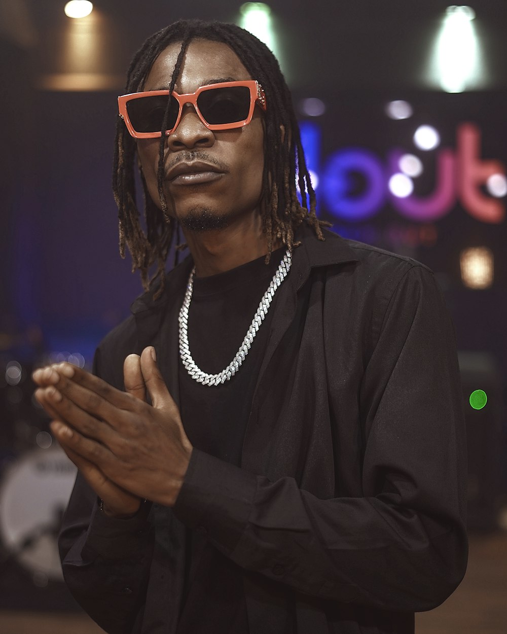 a man wearing red sunglasses and a black shirt