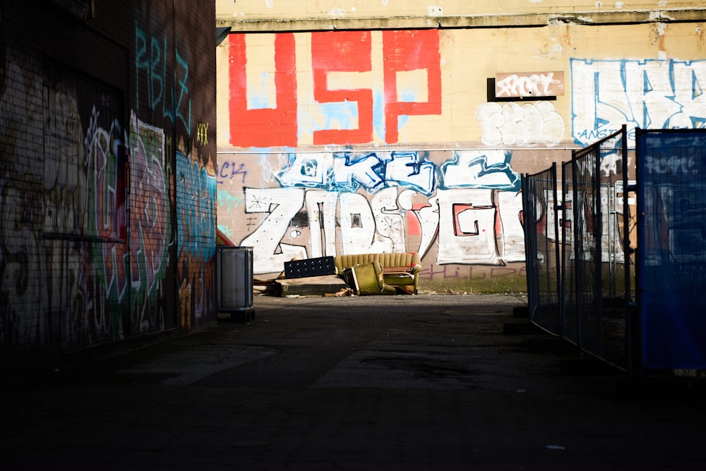 an alley way with graffiti on the walls