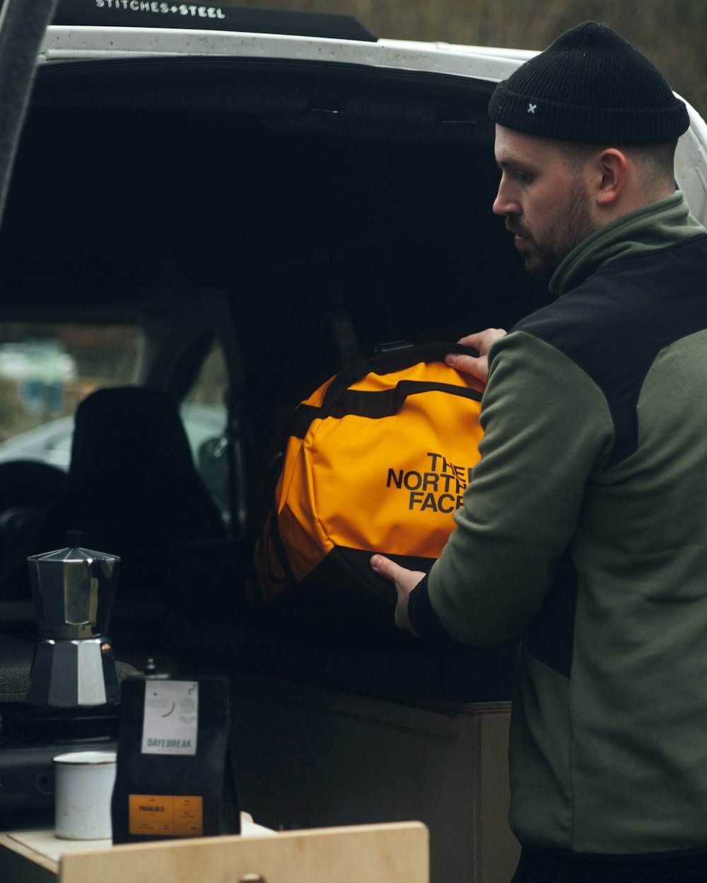 a man loading a bag into the back of a truck