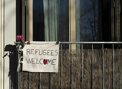 Volunteers warmly greeting a group of refugees at a community center in Medway.