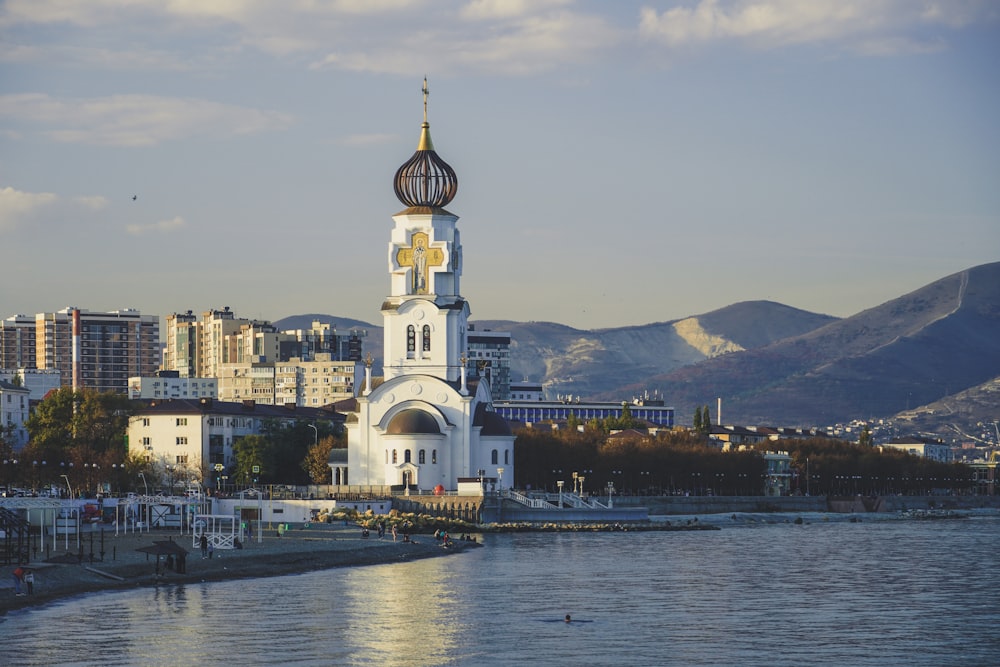 a tall white building with a clock on it's side