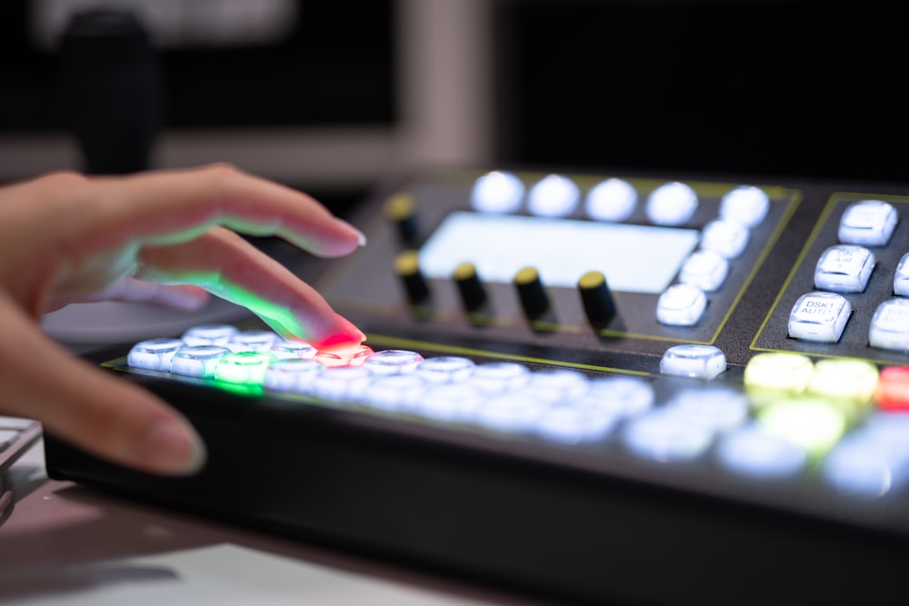 a person is pressing buttons on a control panel