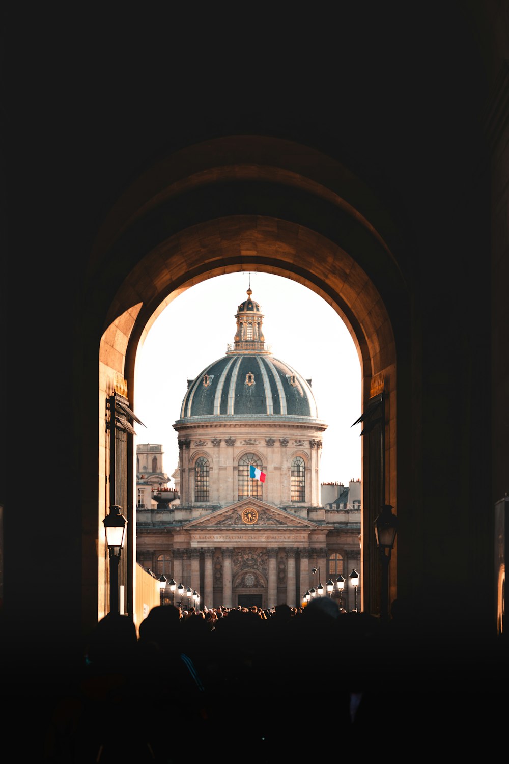 a view of a dome through an arch in a building