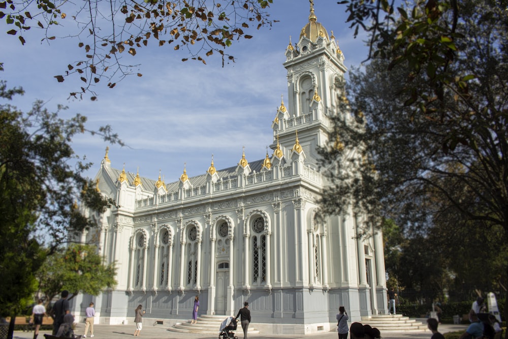 a large white building with a clock tower