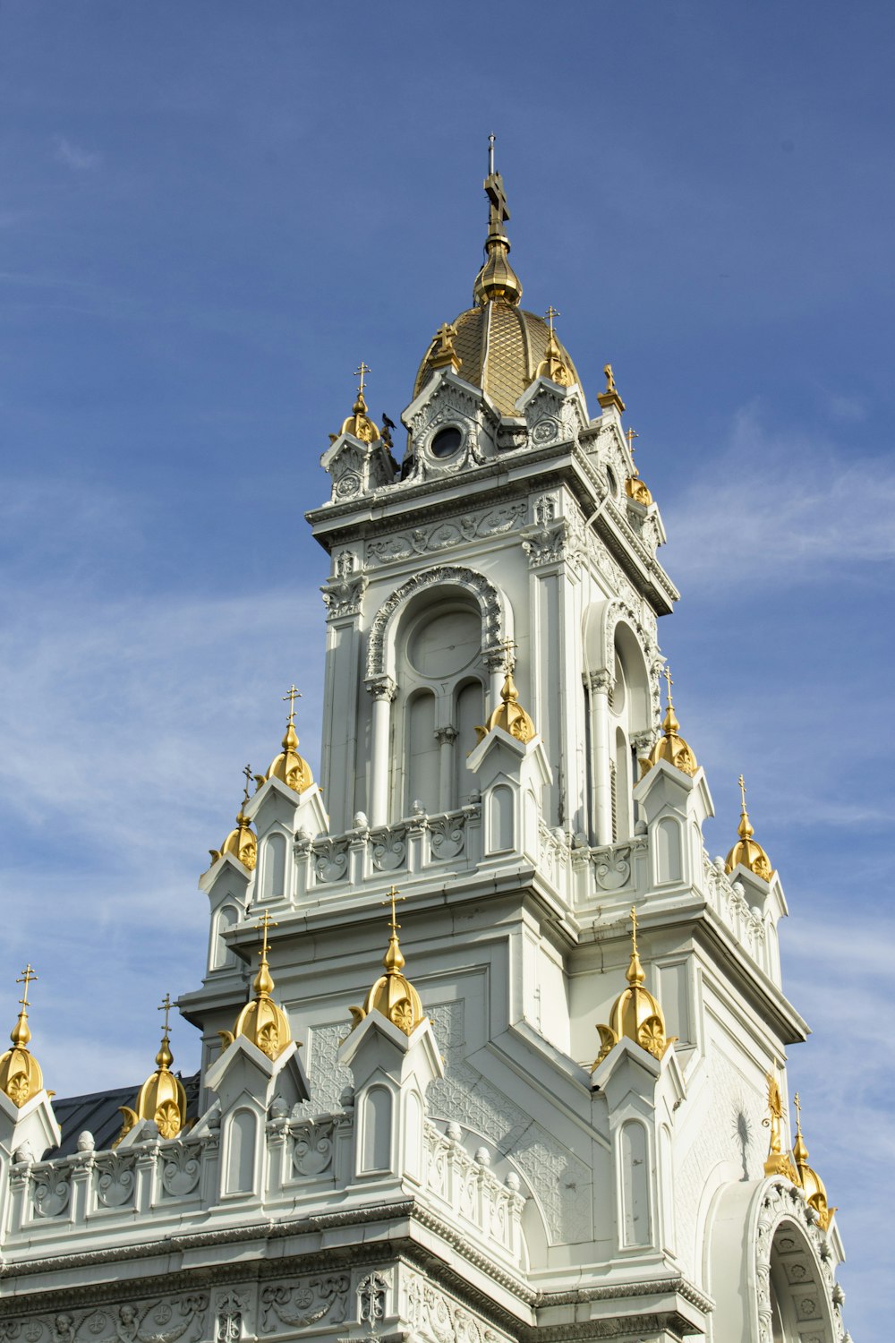 a white and gold building with a clock on it