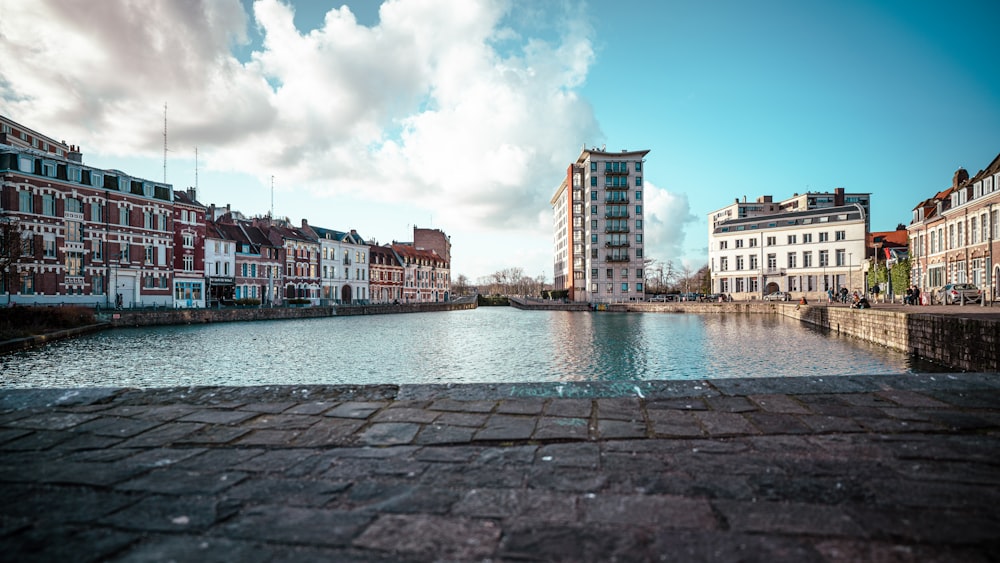 a river running through a city next to tall buildings