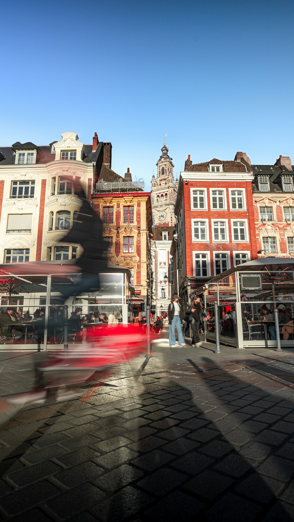 a blurry photo of a red bus on a city street