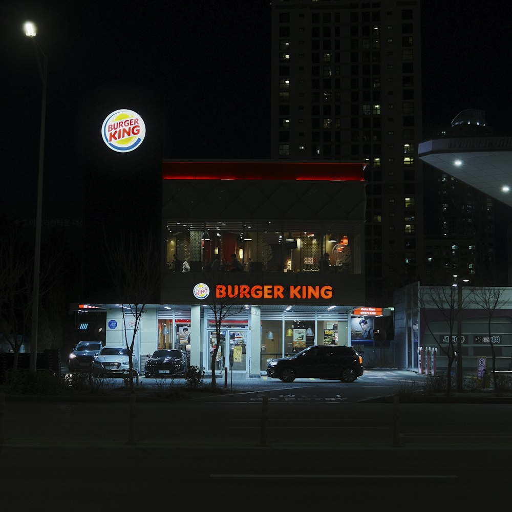 a burger king restaurant lit up at night