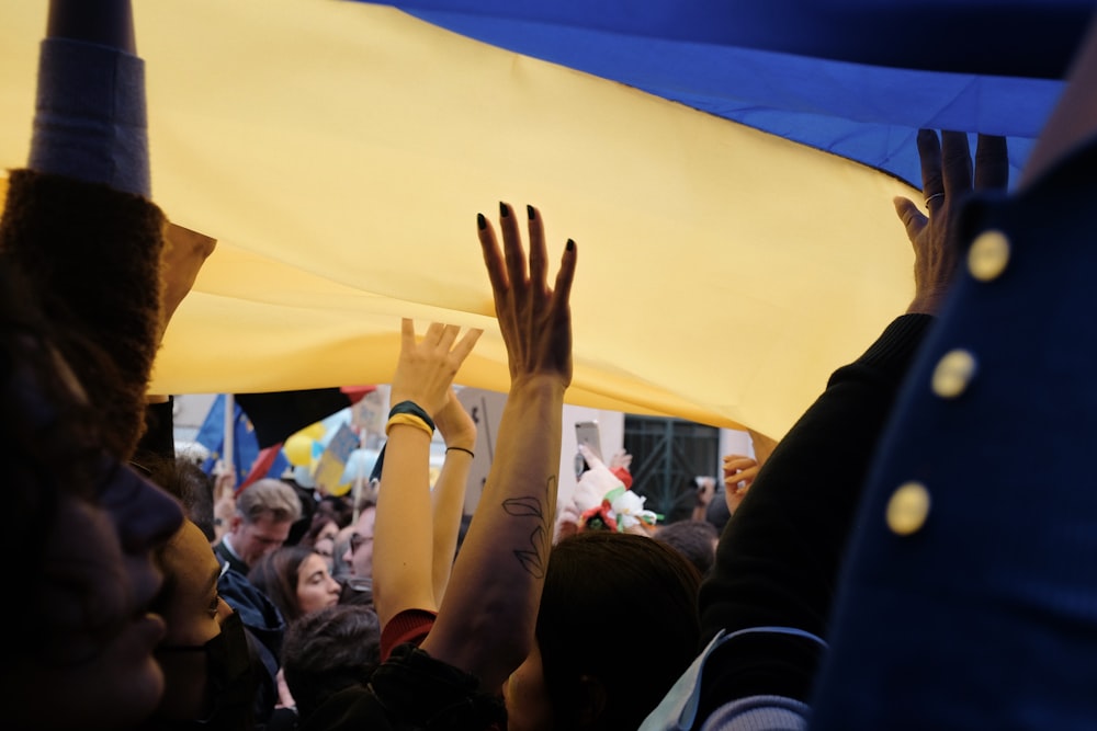 a group of people raising their hands in the air