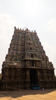 a very tall building with a bunch of statues on top of it